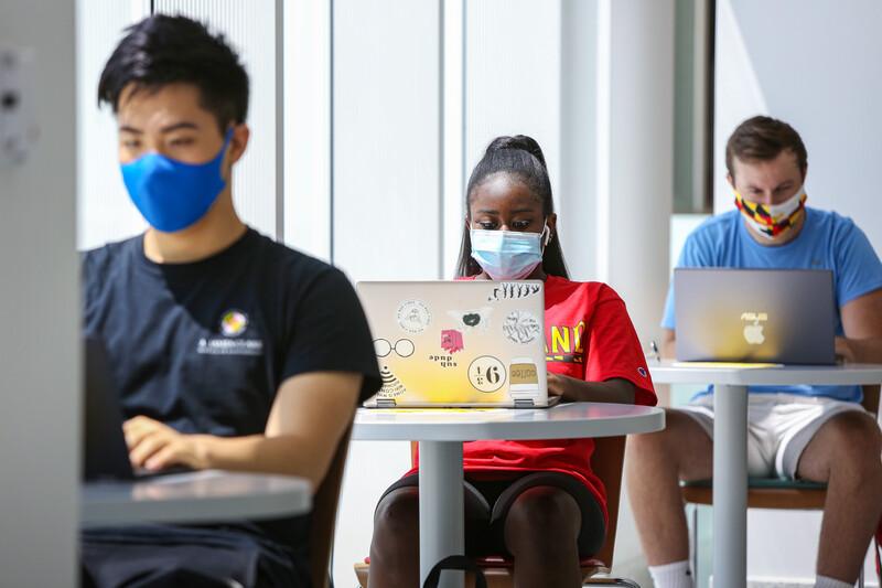 Students wearing masks in the Edward St. John Learning and Teaching Center.